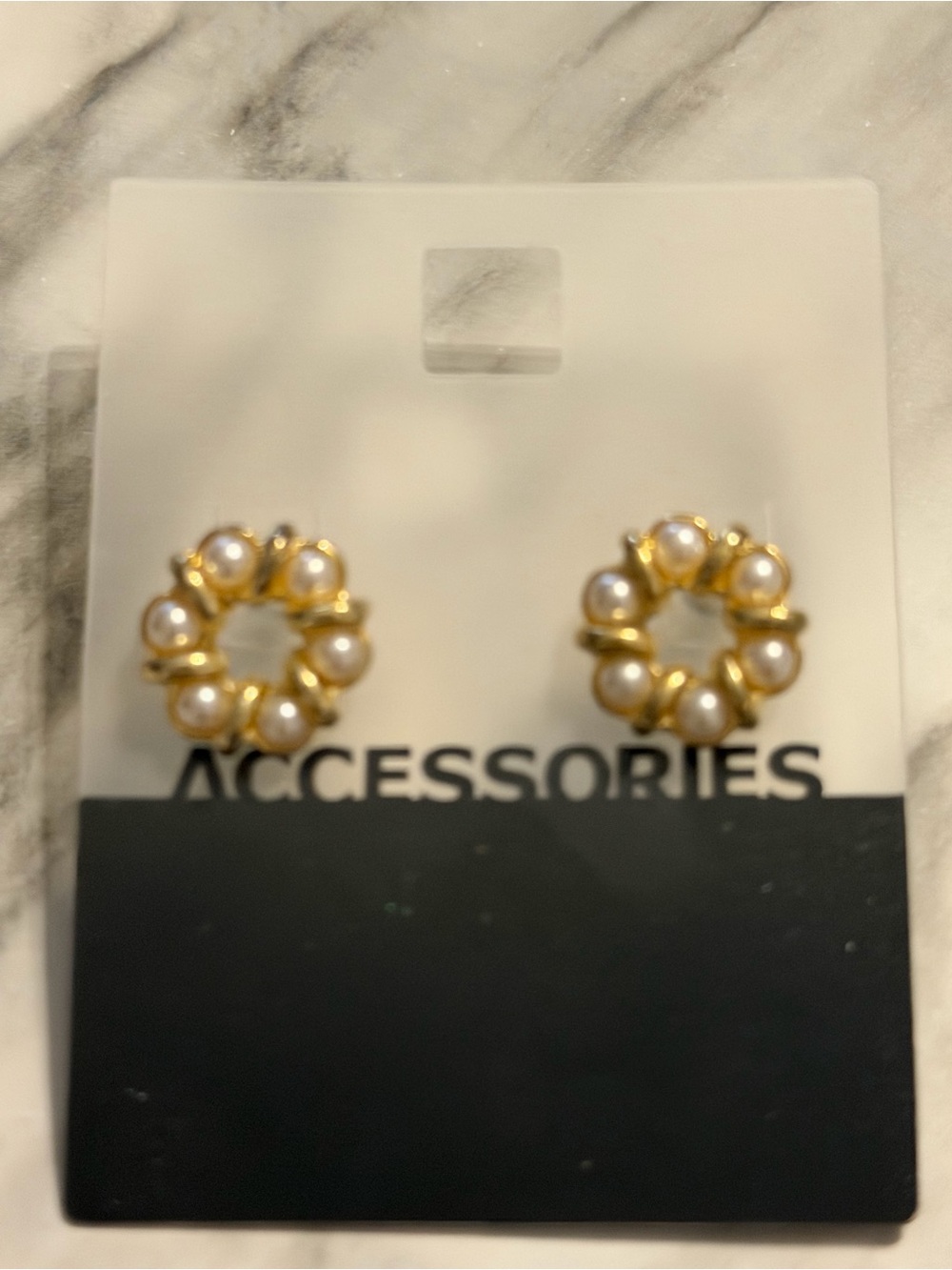gold-tone floral or wreath-style stud earrings featuring small round faux pearls